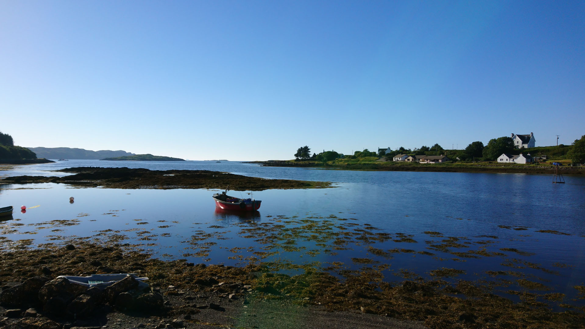 Wide panoramic view of Bunessan bay on the isle of Mull, blue skies.