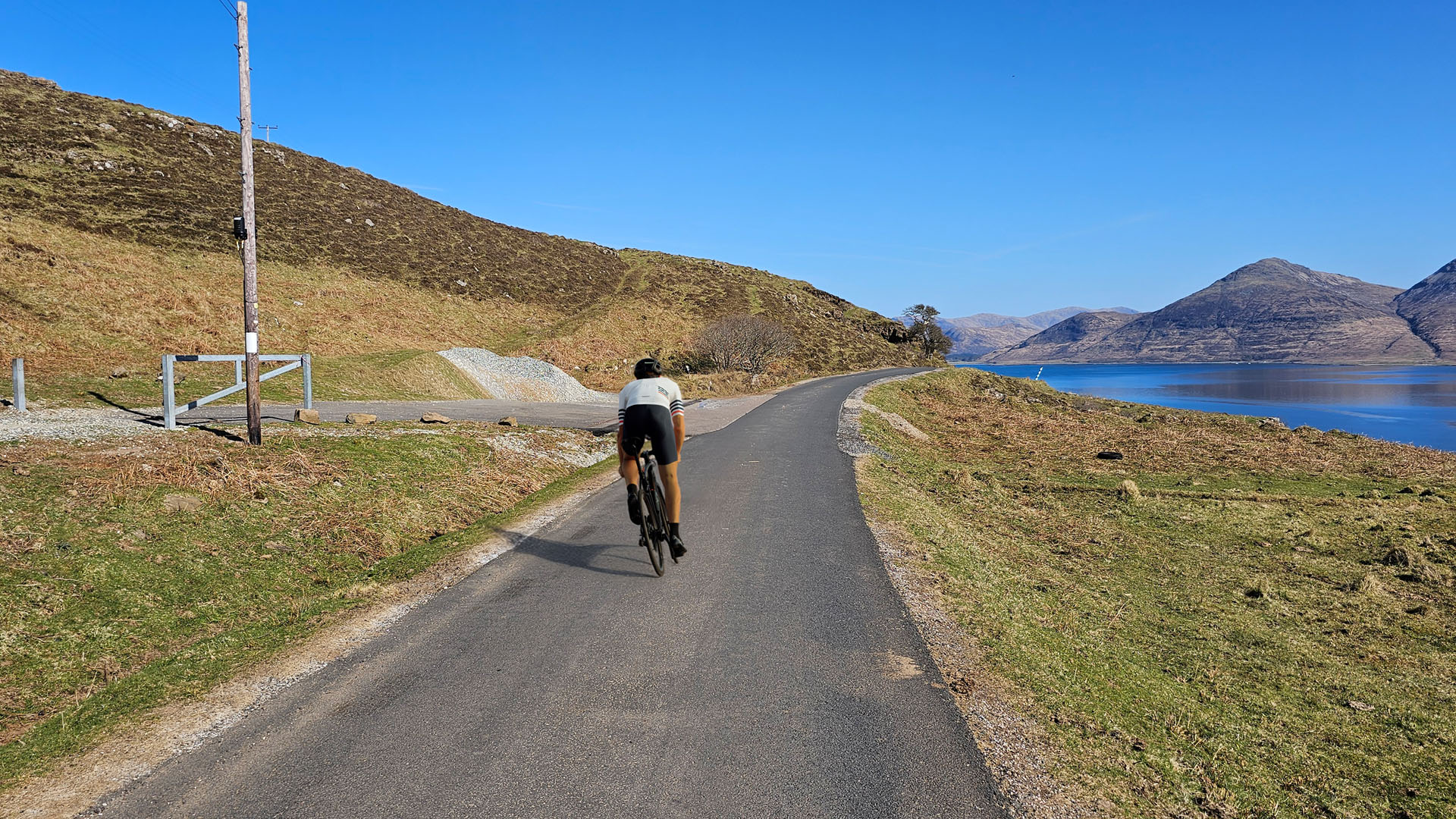 cyclist on a sunny mountain path on the isle of mull.