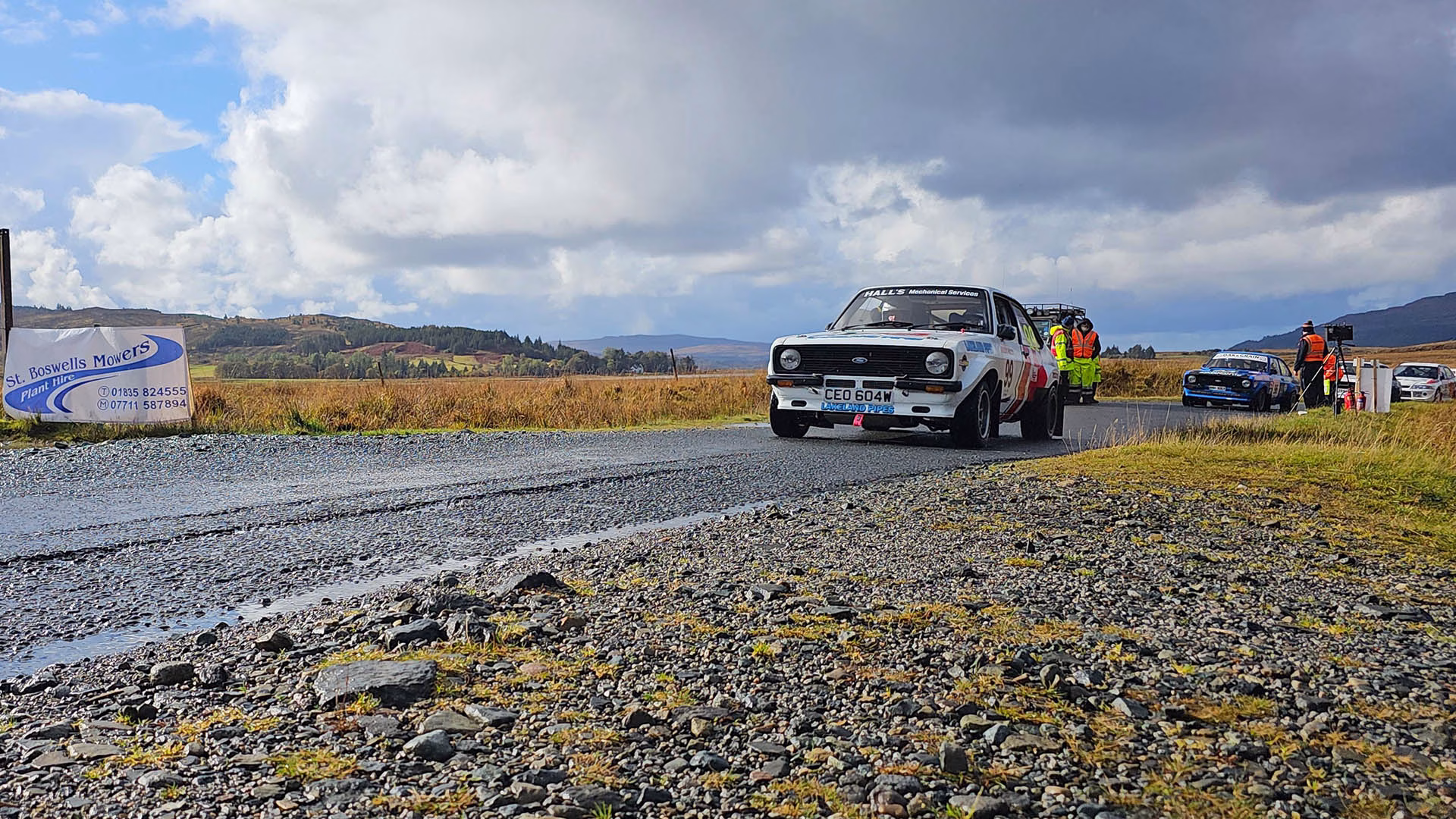 Rally cars lined up and revving at the start line on the Isle of Mull